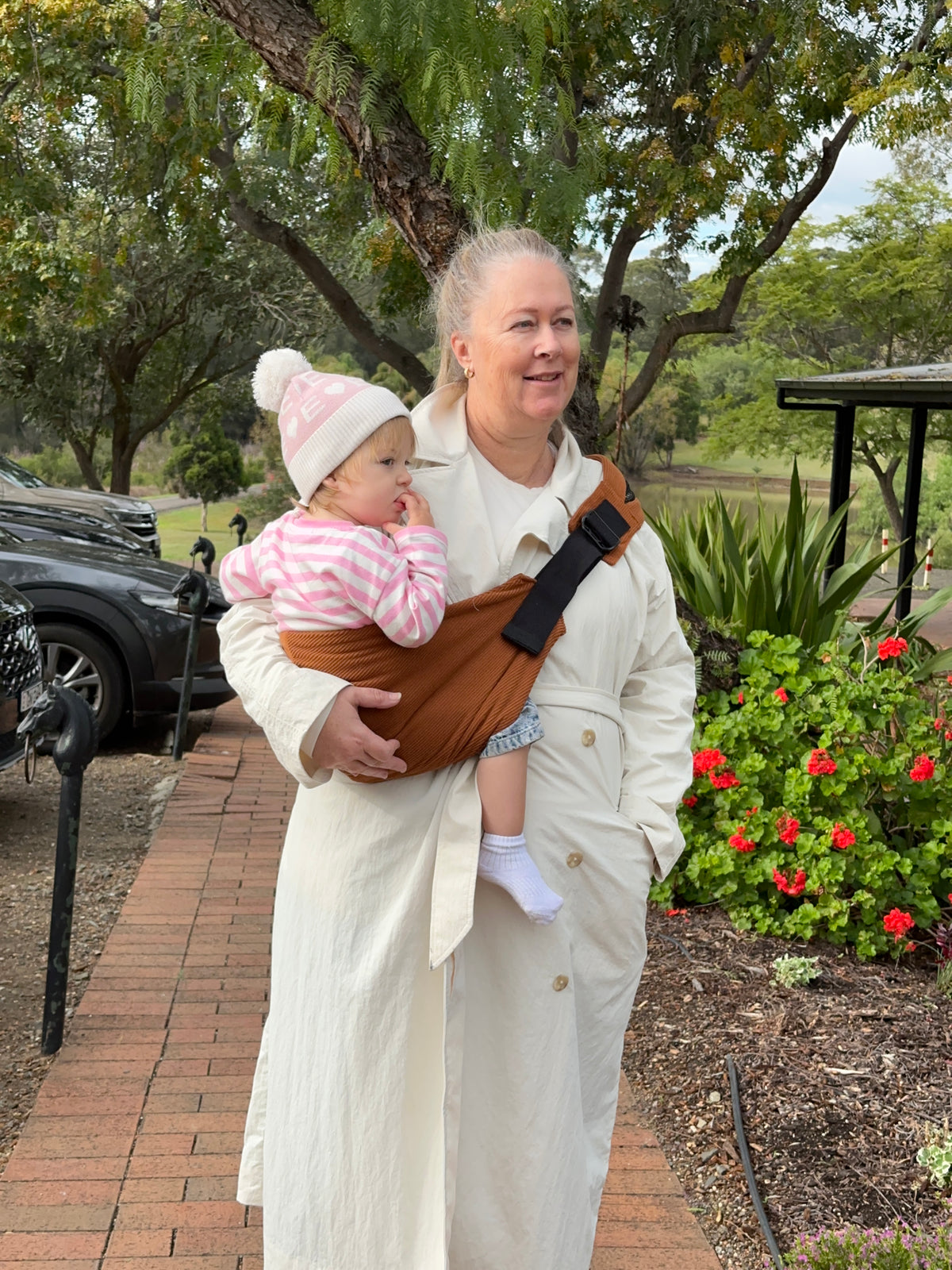 Rust | Grandma carrying toddler outside with flowers and tree's