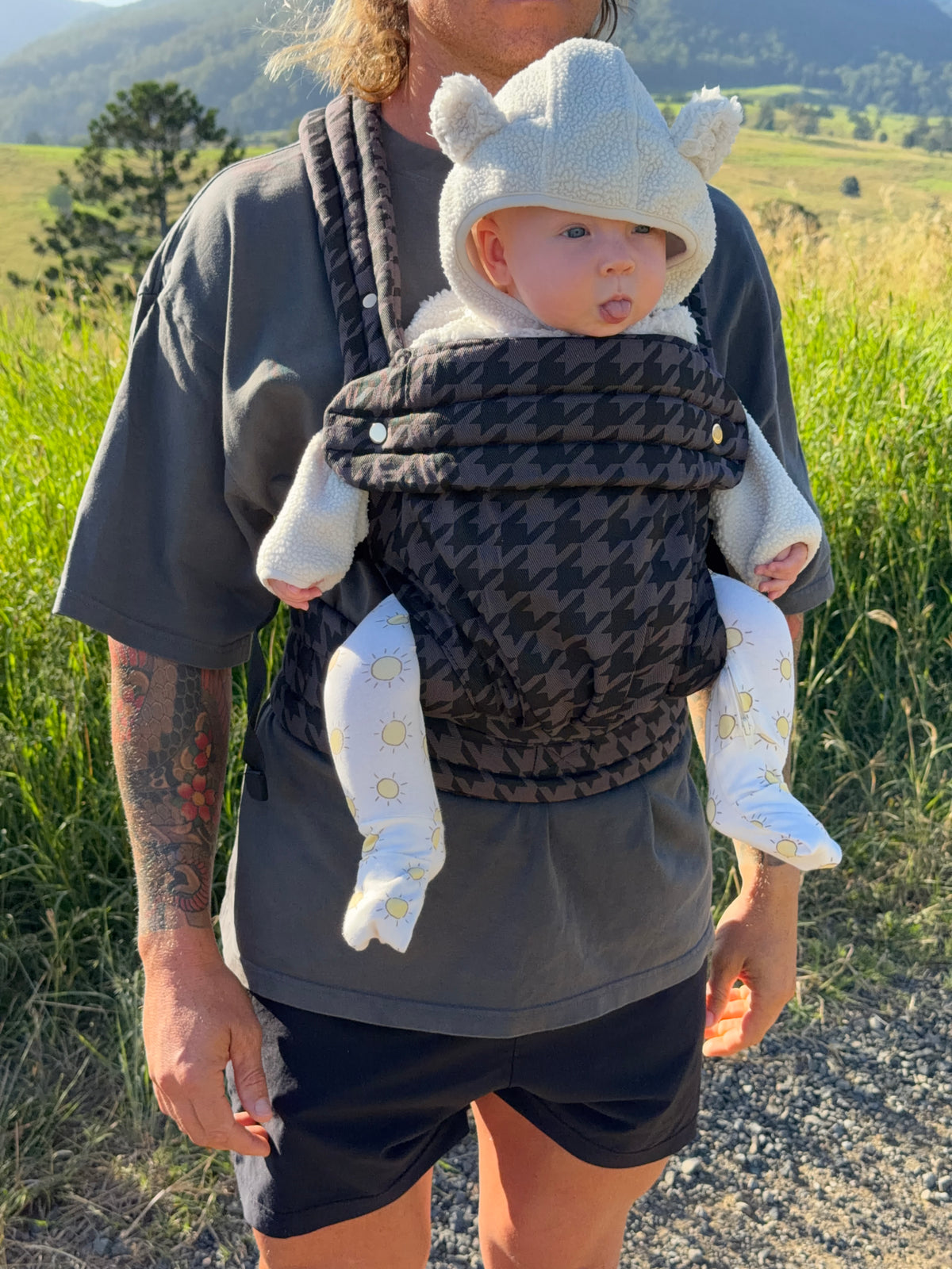 Charcoal | Dad carrying baby in Haven baby Carrier outside in a field. 