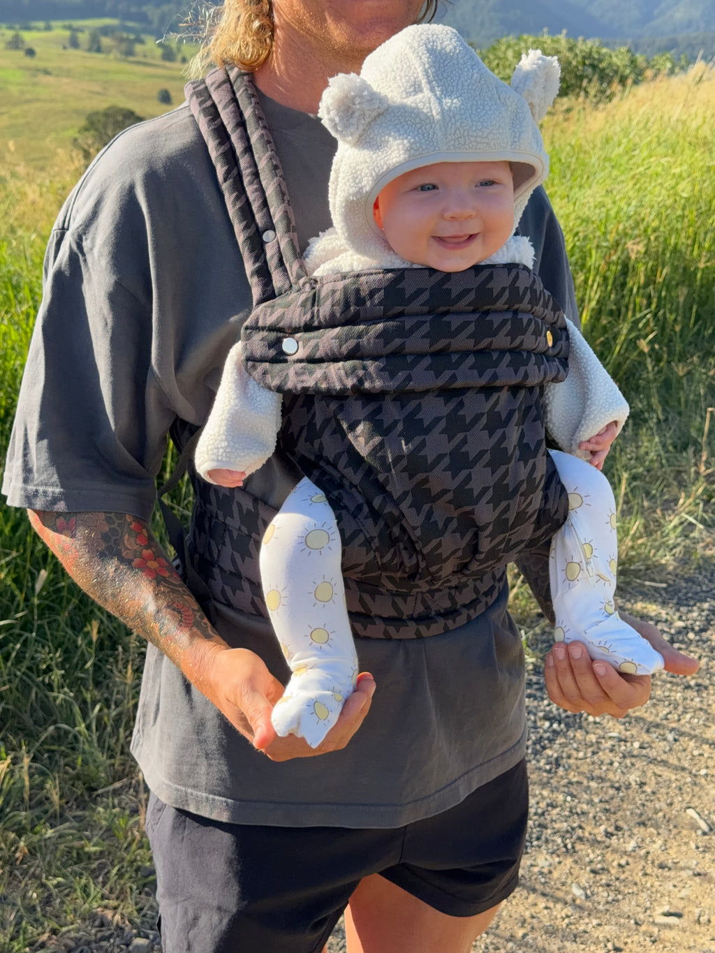 Charcoal | Dad carrying baby in Haven baby Carrier outside in a field. 